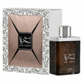 Oud Najdia Lattafa perfume bottle and its decorative packaging box, featuring a dark brown textured bottle with a silver cap next to a white box with black patterns and a metallic rose-gold front panel.