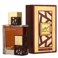 A bottle of Simple & Coul Arabic Eau de Parfum with amber liquid and a gold cap, shown next to its matching brown and gold packaging box on a white background.