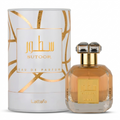 Sutoor Eau de Parfum by Lattafa, featuring a faceted glass bottle filled with amber liquid and a matching white cylindrical box with gold geometric patterns.